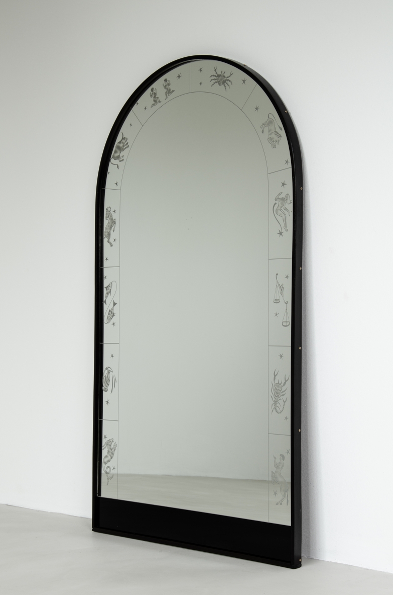 Wall mirror with engravings of zodiac signs, made of crystal and wood. Italy, 1940.