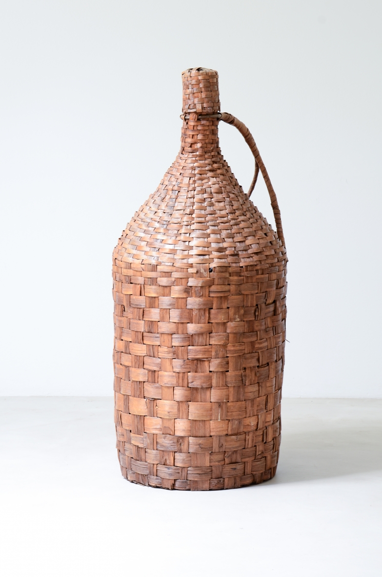 Large bottle made of woven sorghum slats.  Italy 1960 ca.