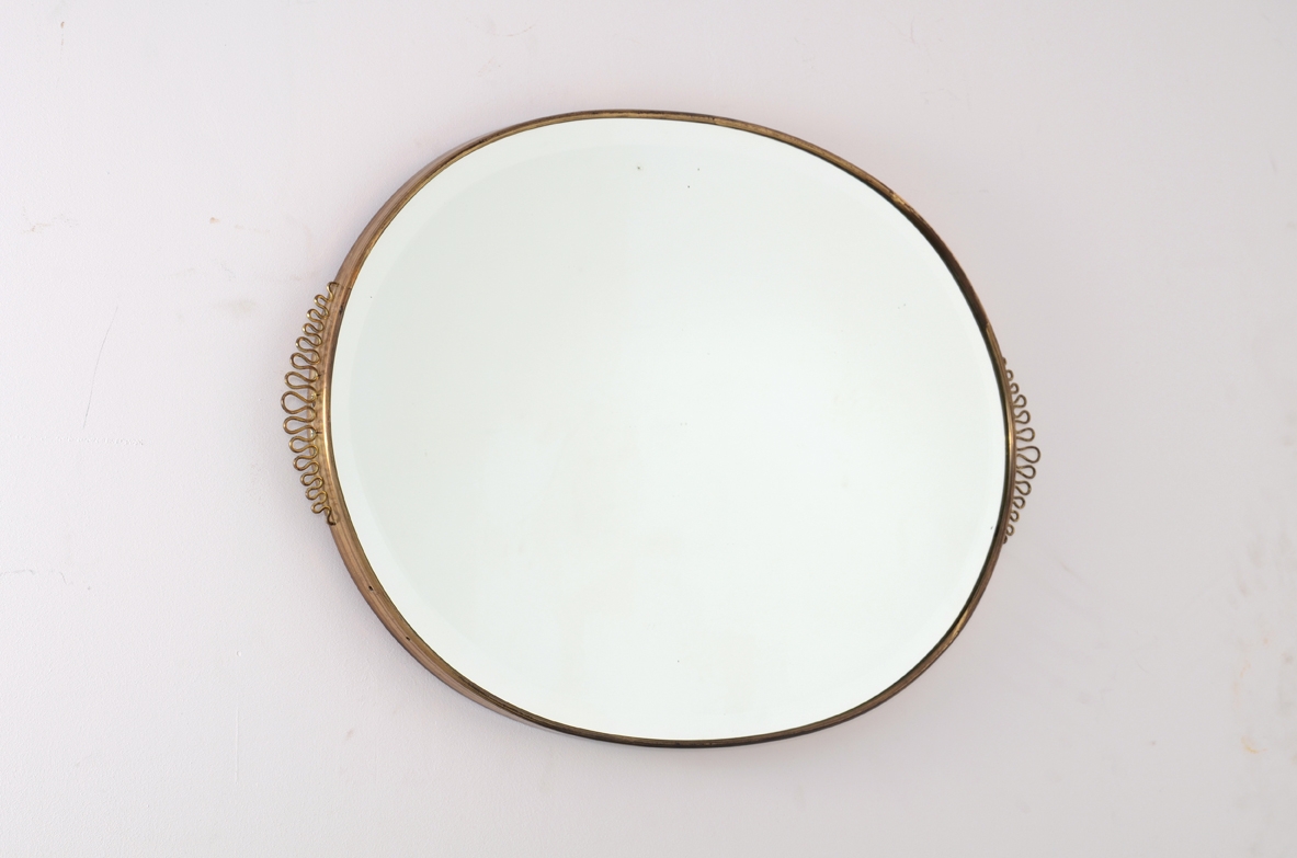 Italian 1950's oval mirror with brass frame.