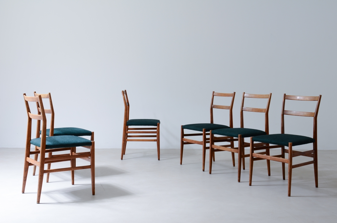 Gio Ponti  Set of 8 light model chairs in black stained wood with fabric covering.  Cassina manufacture 1954.