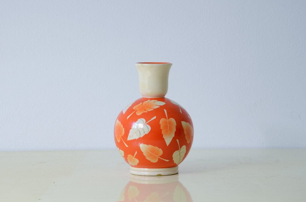 Rometti pottery  Round vase with leaves decoration on a coral colored background. Umbertide manufacture, 1930's.