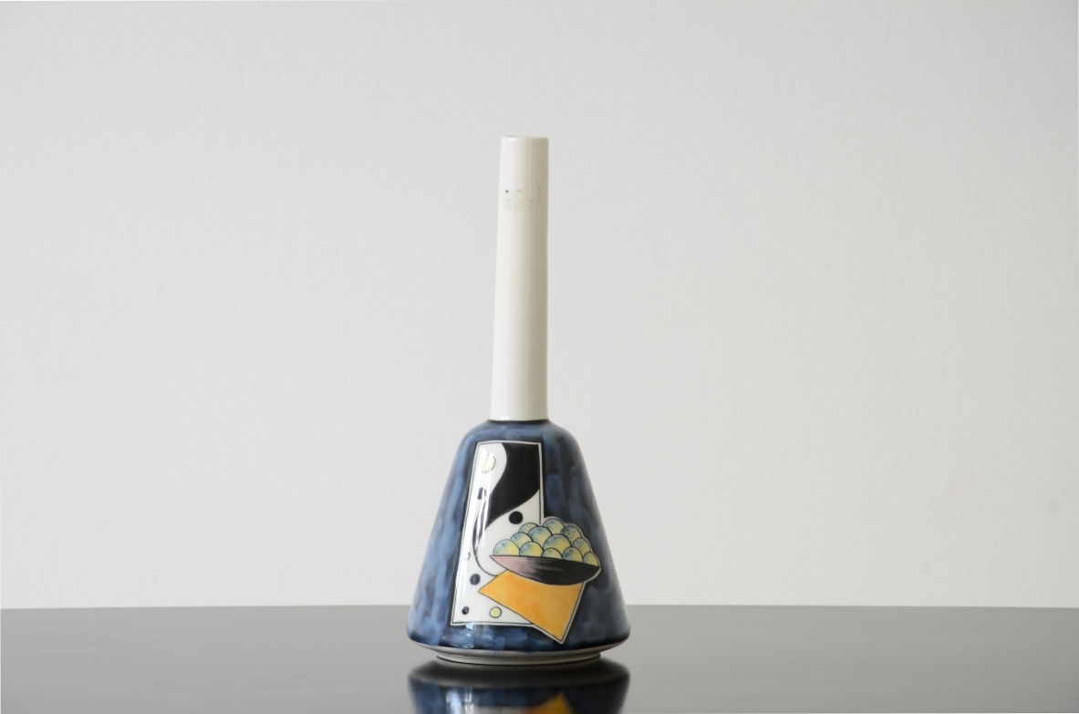 Painted and glazed ceramic vase with long white ceramic stem.