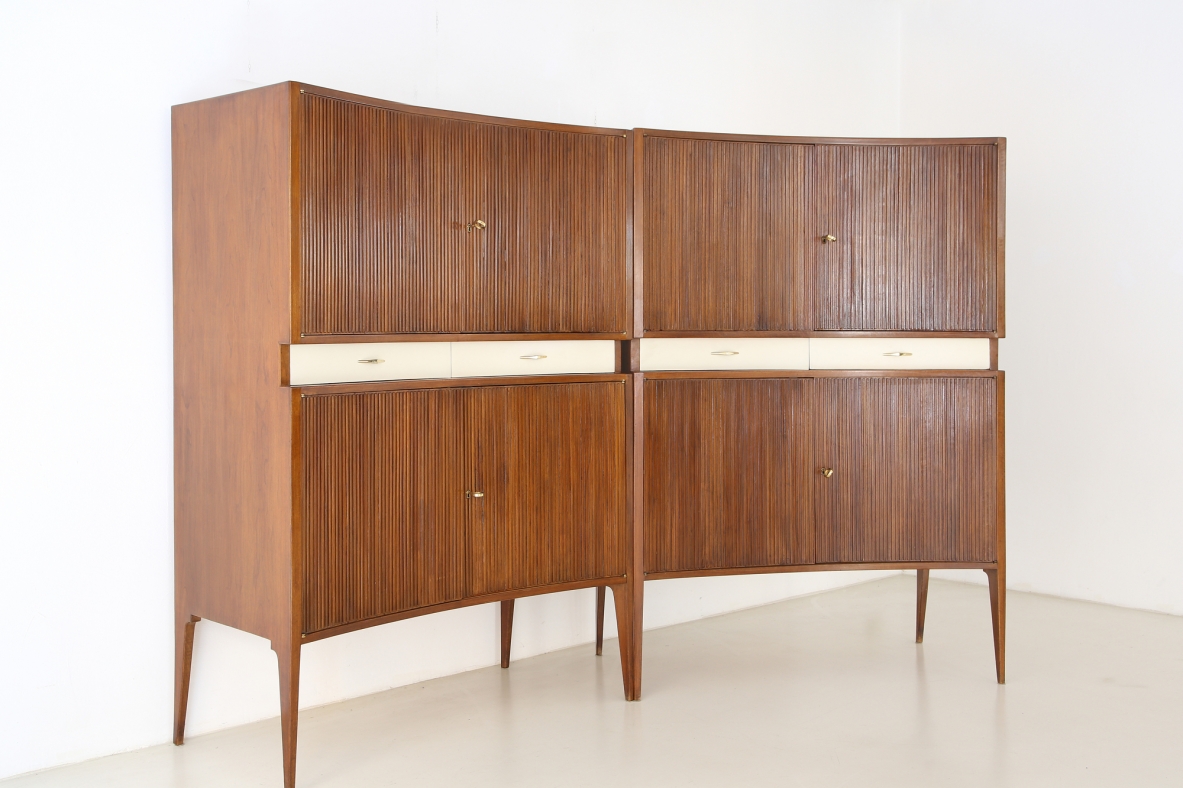 Pair of 1950's unique highboards with grinded concave front and very thin long elegant legs, attr. to Guglielmo Ulrich.