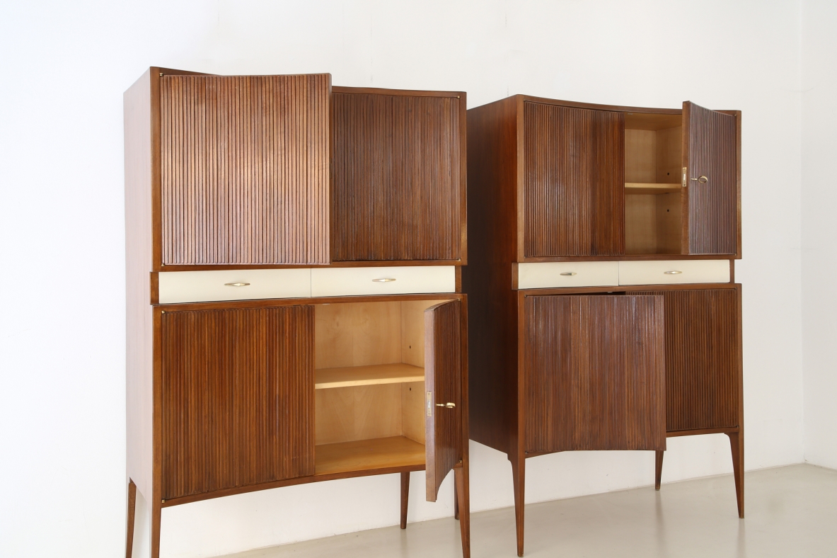 Pair of 1950's unique highboards with grinded concave front and very thin long elegant legs, attr. to Guglielmo Ulrich.