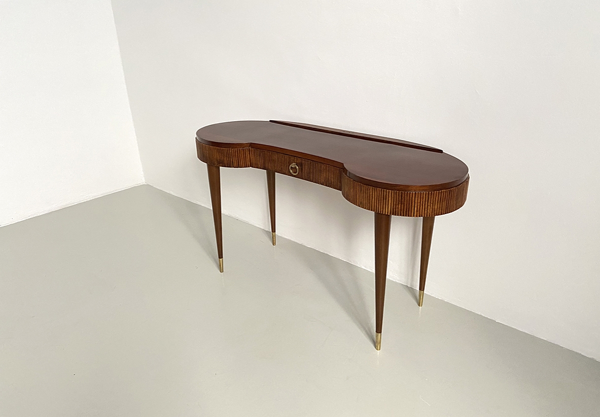 Elegant Italian 1950's console table with thin long legs and brass tips.