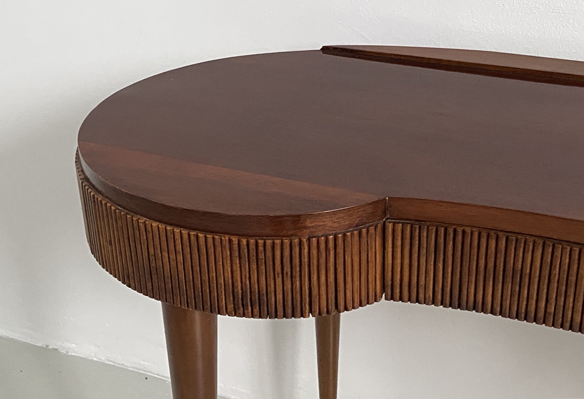 Elegant Italian 1950's console table with thin long legs and brass tips.