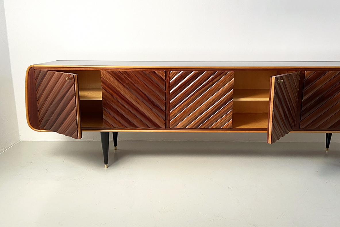 Splendid Italian 1950's sideboard with a very refined wooden front and four thin legs with brass tips.