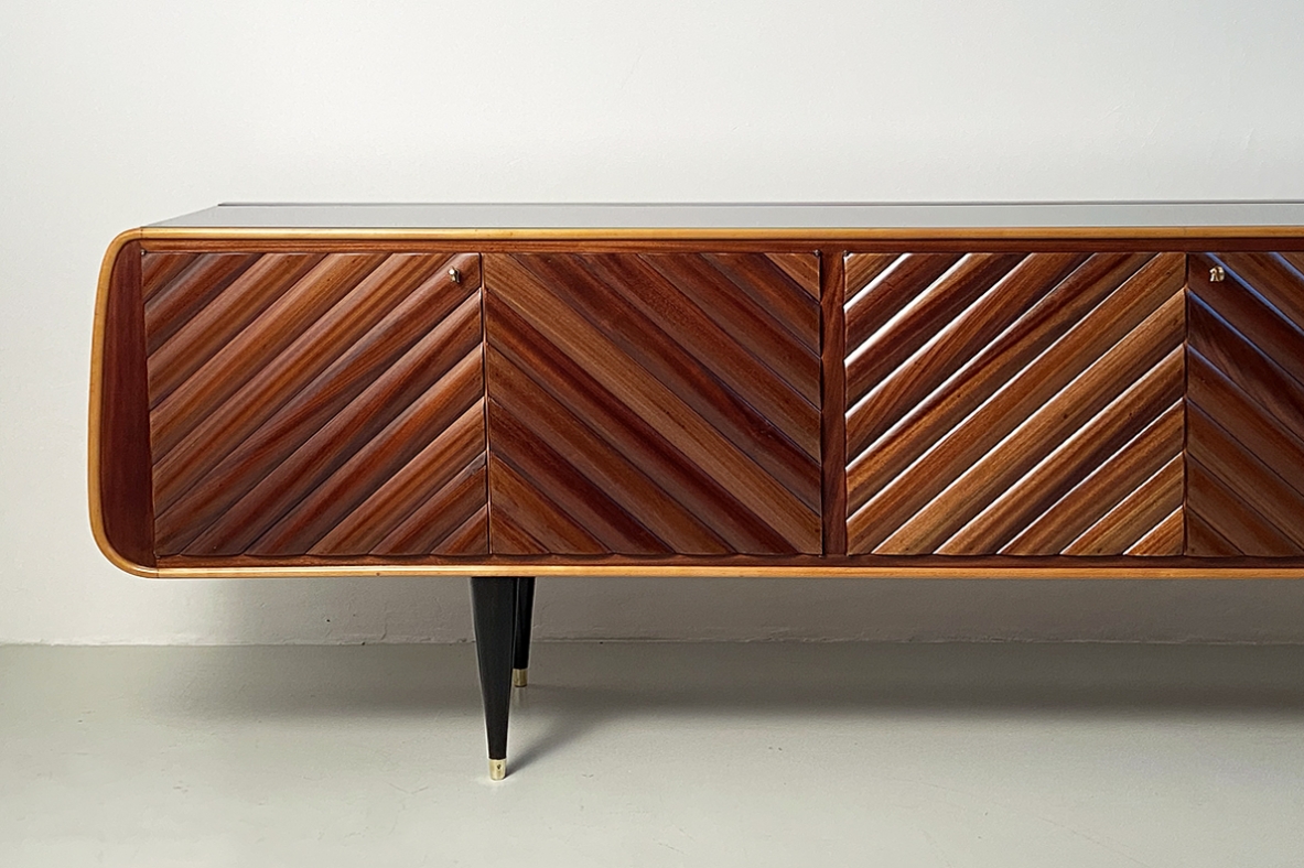 Splendid Italian 1950's sideboard with a very refined wooden front and four thin legs with brass tips.