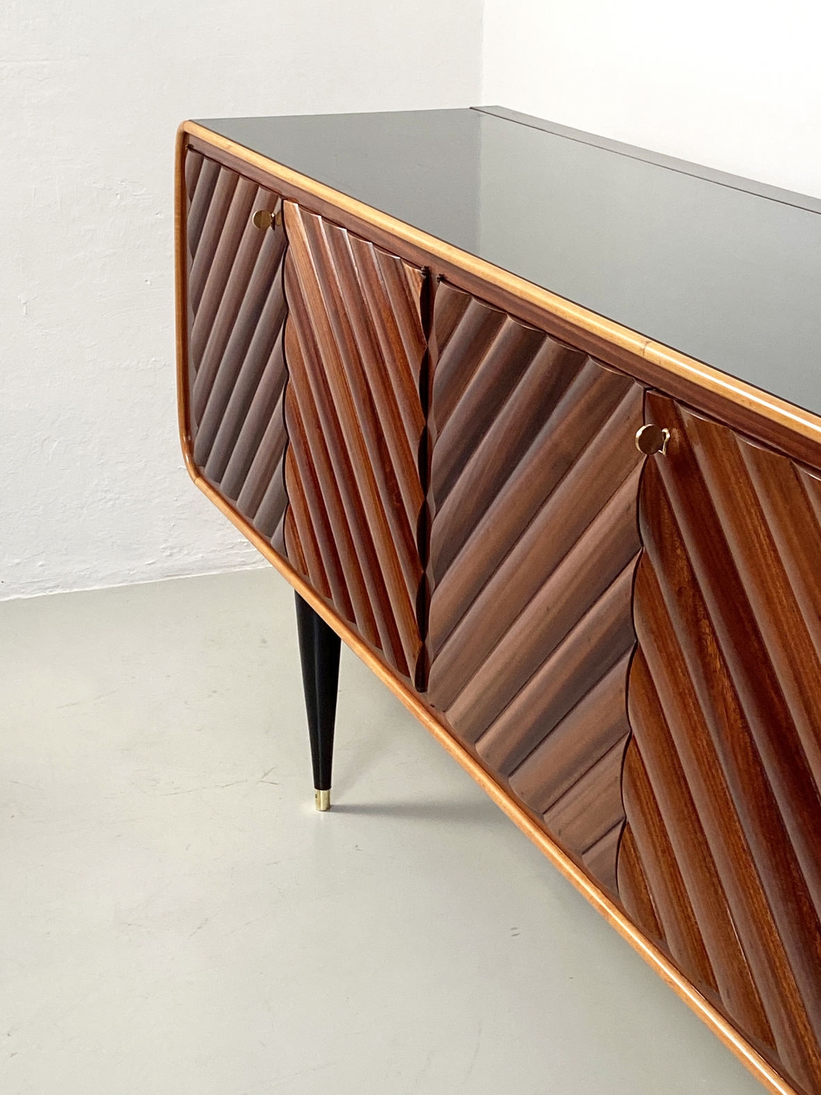Splendid Italian 1950's sideboard with a very refined wooden front and four thin legs with brass tips.