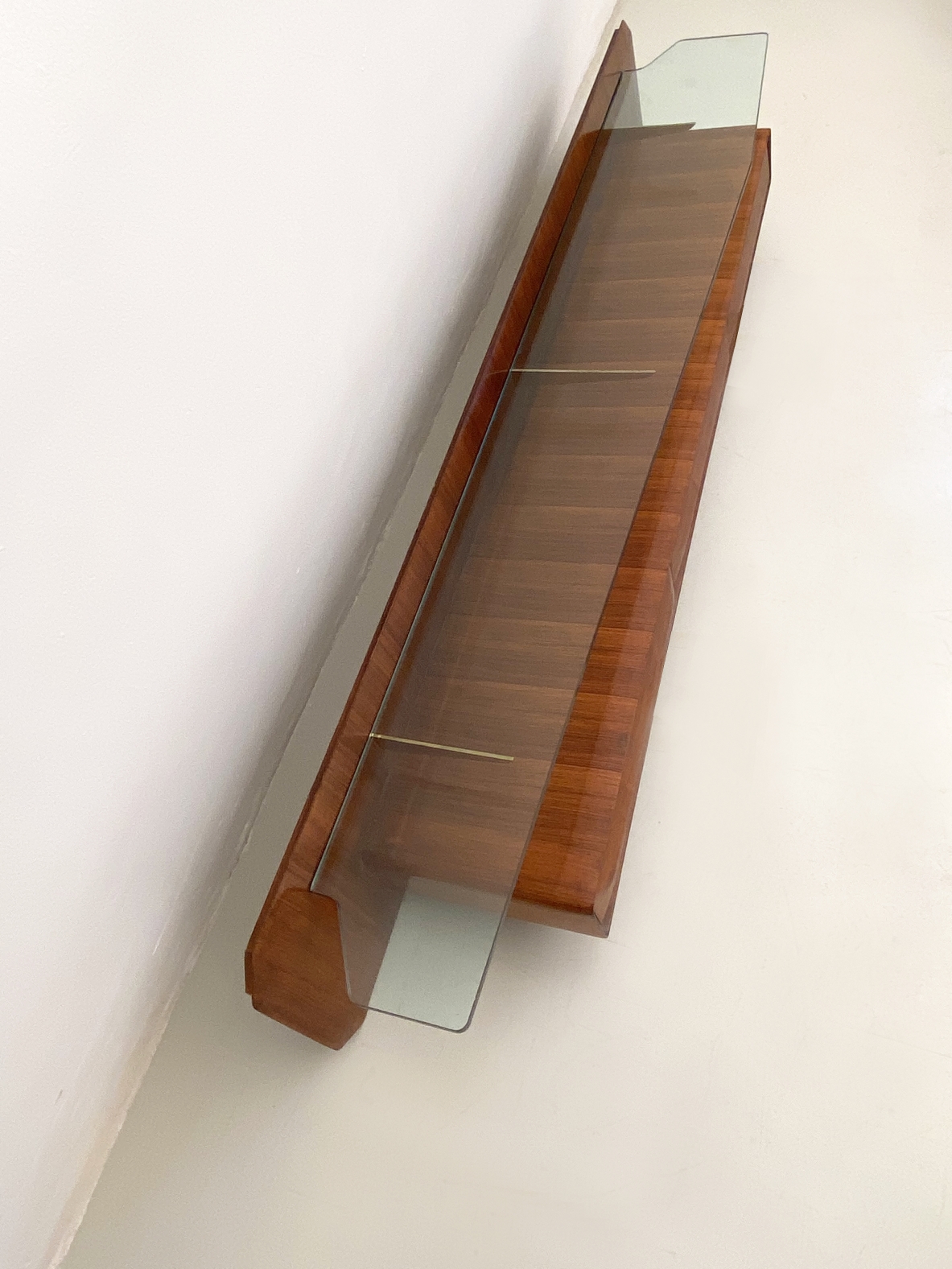 Italian 1960's console table in rosewood with a very nice shaped thick crystal glass and brass details.