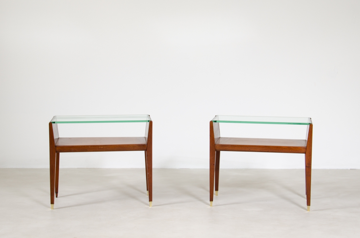 Pair of wooden bedside tables with glass top and brass tips. Italian manufacture, 1950's.