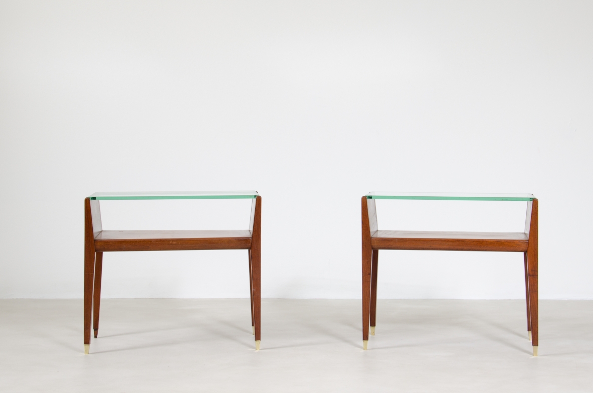 Pair of wooden bedside tables with glass top and brass tips. Italian manufacture, 1950's.