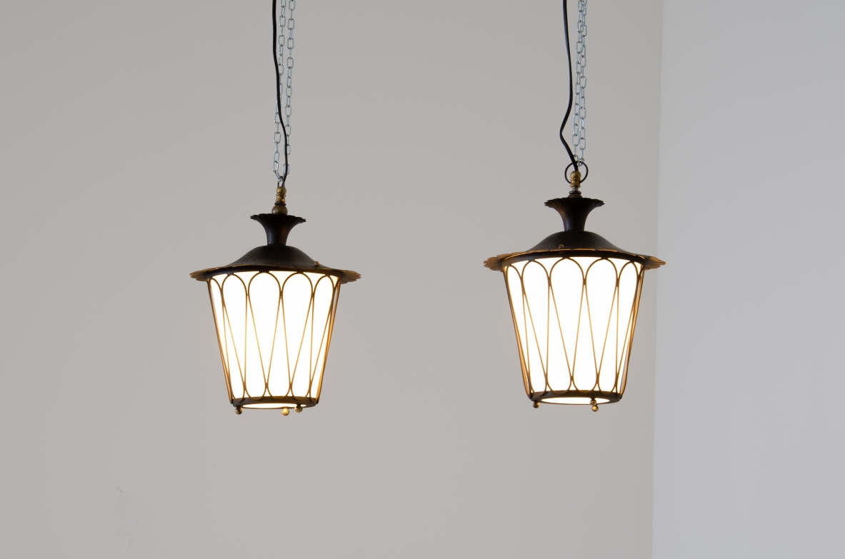 Pair of chandeliers with dark green metal structure and brass details. White glass curved inside.  Manifactured by Casa & Giardino, Milano, 1930s.