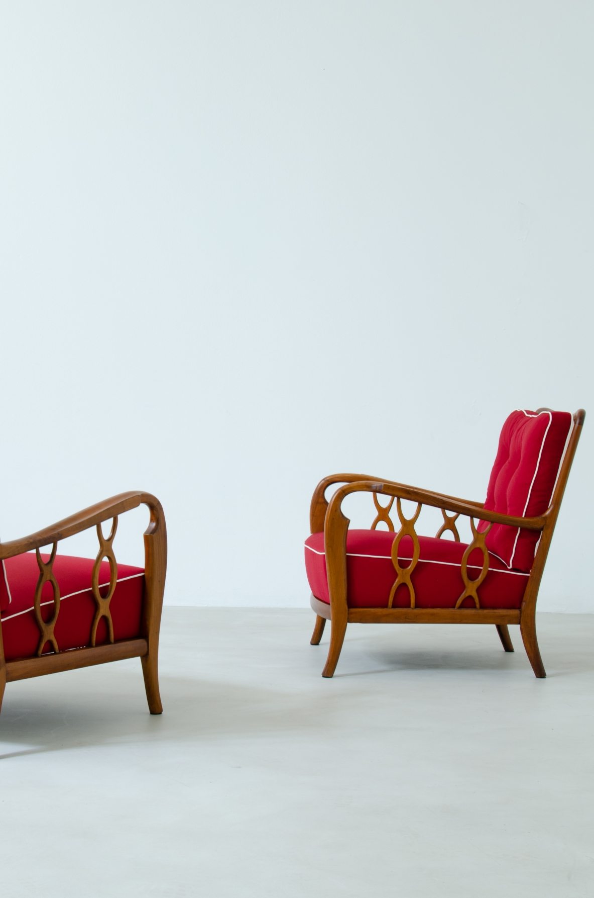 Pair of cherry wood armchairs with ribbon motif on the sides. Seat and back in padded fabric.  Attribution Paolo Buffa 1930s.
