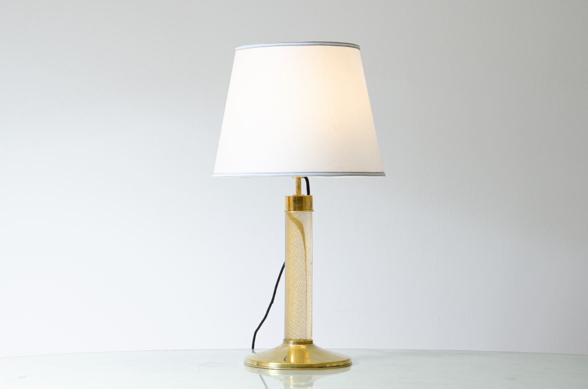 Table lamp with brass base and Murano glass stem, shade in fabric.  Italian manufacture, 1940's. 