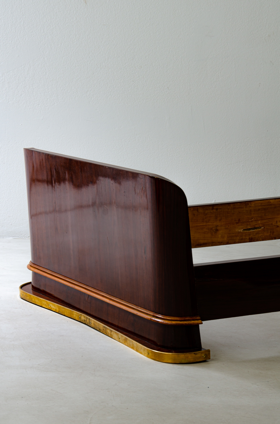 Pair of elegant rosewood beds with blond maple profiles and parchment headboard, brass details.  Italian manufacture, 1940's.