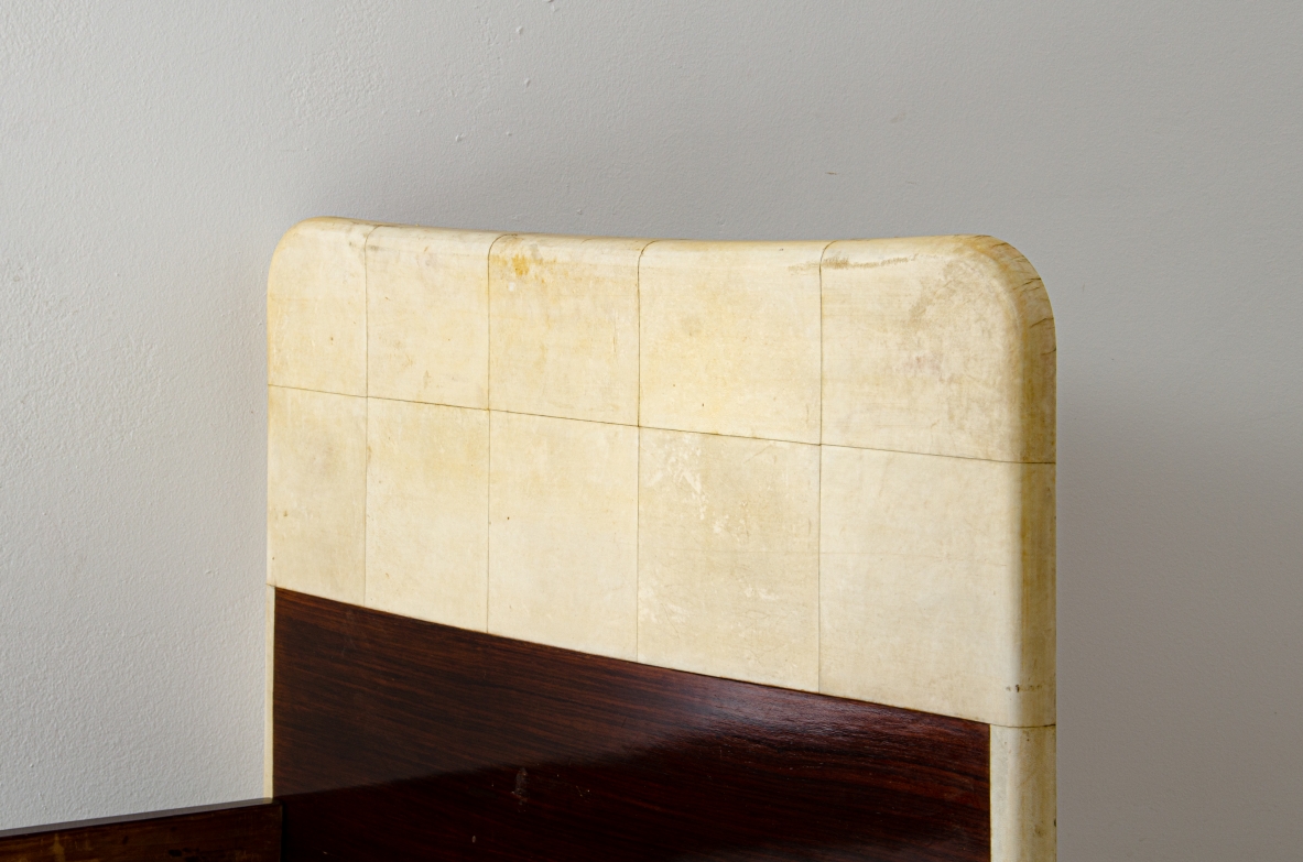 Pair of elegant rosewood beds with blond maple profiles and parchment headboard, brass details.  Italian manufacture, 1940's.