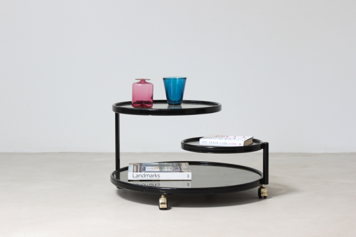 Coffee table in lacquered metal with mirrored top and jointed glass shelves.  Italian manufacture,1970's.