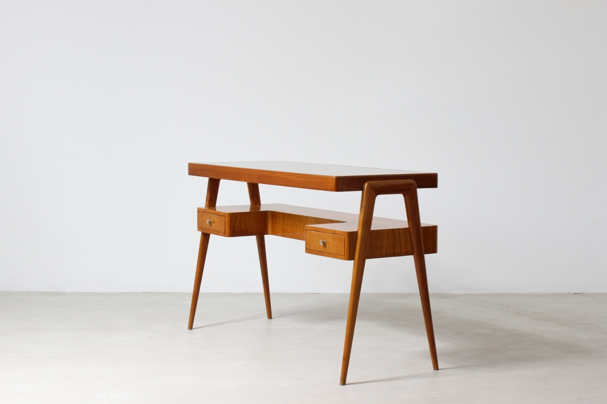 Consolle desk in blond wood with glass top and shaped shelf with two drawers on the front.  Italian manufacture, 1950's.