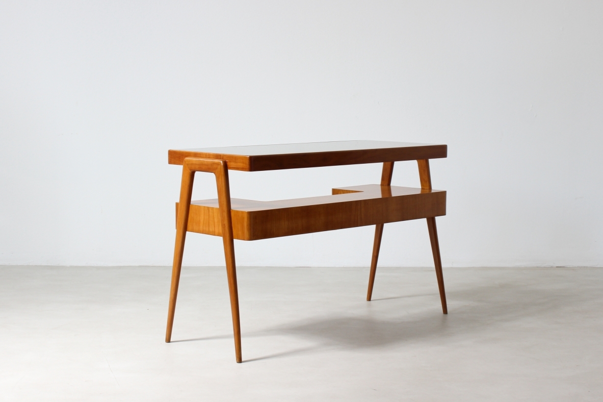Consolle desk in blond wood with glass top and shaped shelf with two drawers on the front.  Italian manufacture, 1950's.