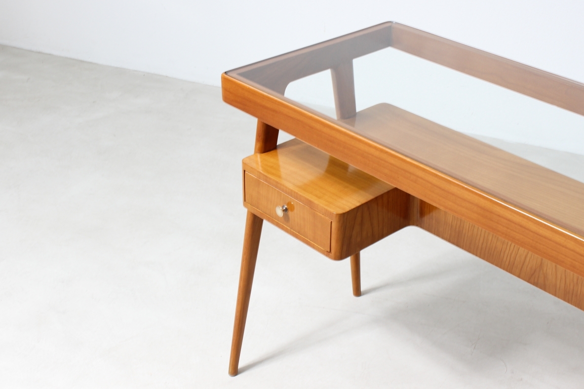 Consolle desk in blond wood with glass top and shaped shelf with two drawers on the front.  Italian manufacture, 1950's.