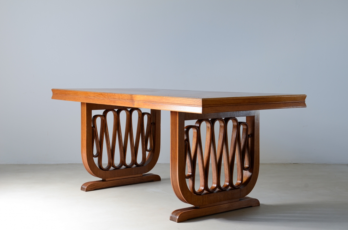 Extraordinary oak table with grissinate uprights and ribbon motif in the style of the period, top with shaped thickness.  Italian manifacture, 1940's