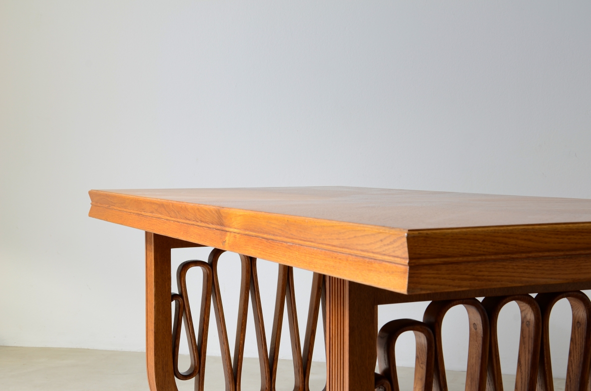 Extraordinary oak table with grissinate uprights and ribbon motif in the style of the period, top with shaped thickness.  Italian manifacture, 1940's
