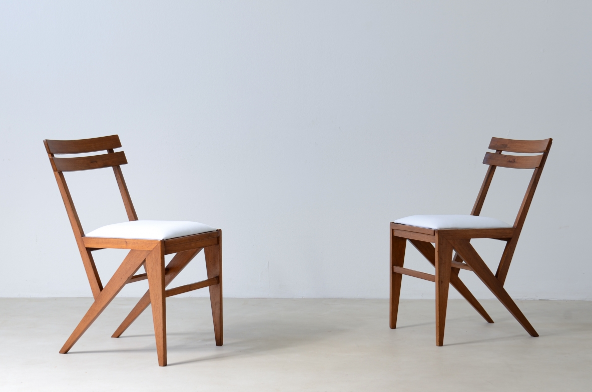 Pair of modernist wooden chairs with upholstered seat.