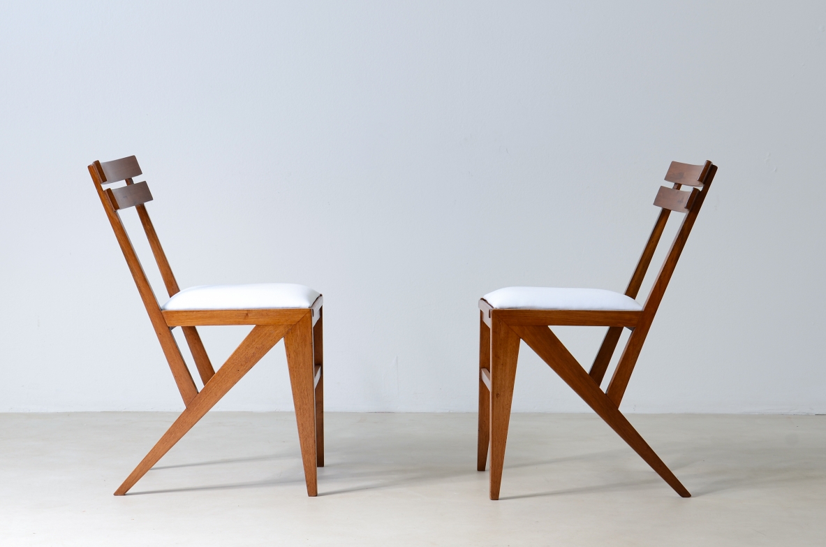 Pair of modernist wooden chairs with upholstered seat.
