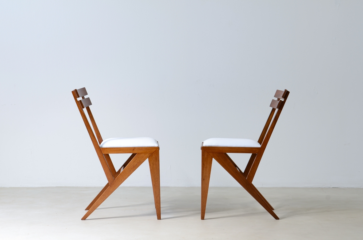 Pair of modernist wooden chairs with upholstered seat.