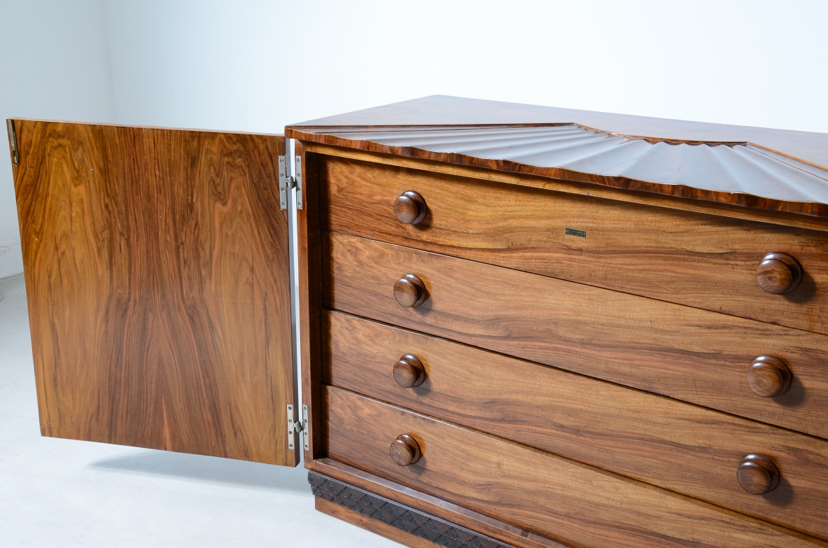 Borsani Varedo  Unique chest of drawers made of a very high quality with 4 drawers hidden by two doors with grooves that continue on the top forming a shell design.