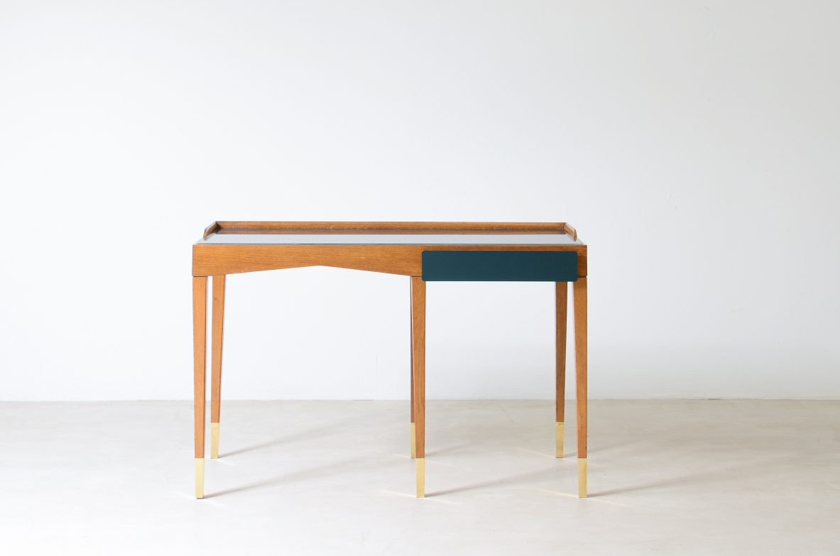 Refined oak writing desk with petrol green opaline glass top and backsplash.  Shaped drawer of the same color covered in polypropylene. Long thin legs with brass tips.  Attributed to Gio Ponti, early 1950s manufacture.