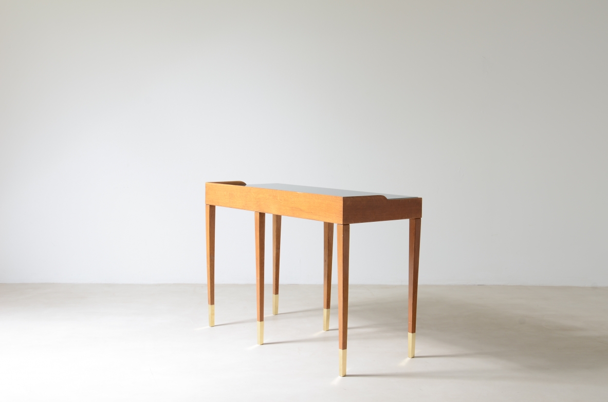 Refined oak writing desk with petrol green opaline glass top and backsplash.  Shaped drawer of the same color covered in polypropylene. Long thin legs with brass tips.  Attributed to Gio Ponti, early 1950s manufacture.