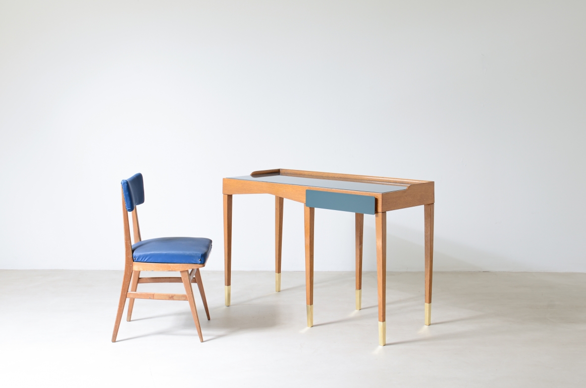 Refined oak writing desk with petrol green opaline glass top and backsplash.  Shaped drawer of the same color covered in polypropylene. Long thin legs with brass tips.  Attributed to Gio Ponti, early 1950s manufacture.