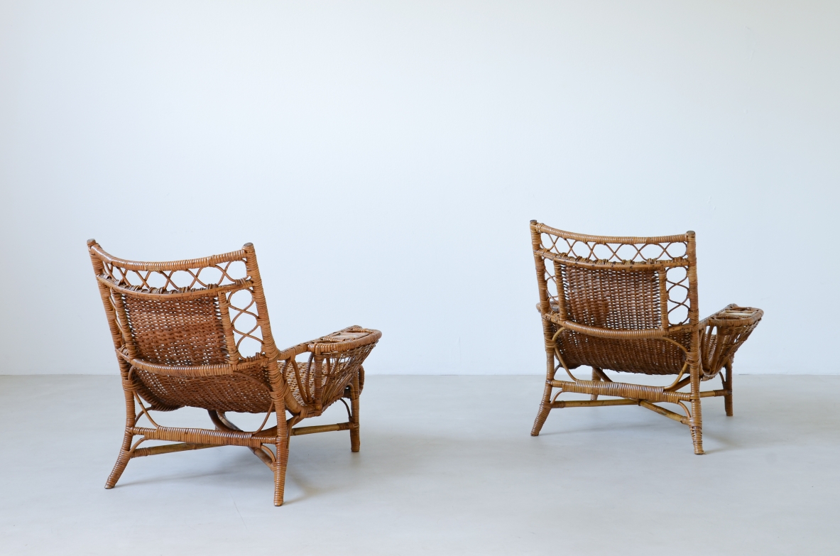 Pair of elegant willow armchairs with weaving on the seat and back as well as composed details, shapes and decorations.  Italian manufacture 1950ca.