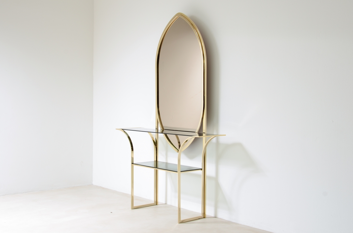 Console table in curved brass with shelves in grey blue glass and a huge mirror in burned brown color.  1970s Italian manufacture. 