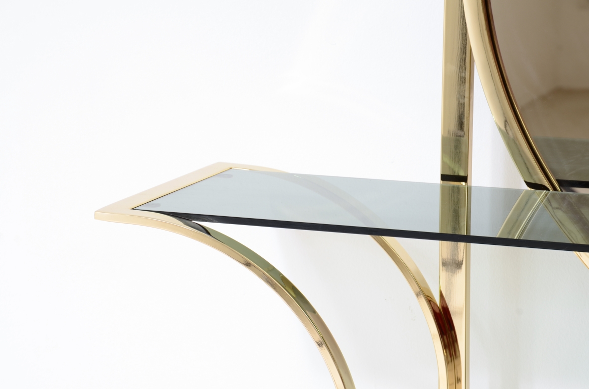 Console table in curved brass with shelves in grey blue glass and a huge mirror in burned brown color.  1970s Italian manufacture. 