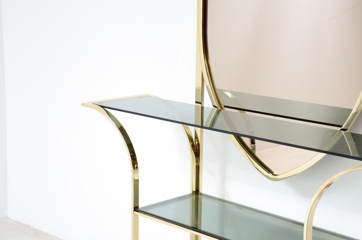 Console table in curved brass with shelves in grey blue glass and a huge mirror in burned brown color.  1970s Italian manufacture. 