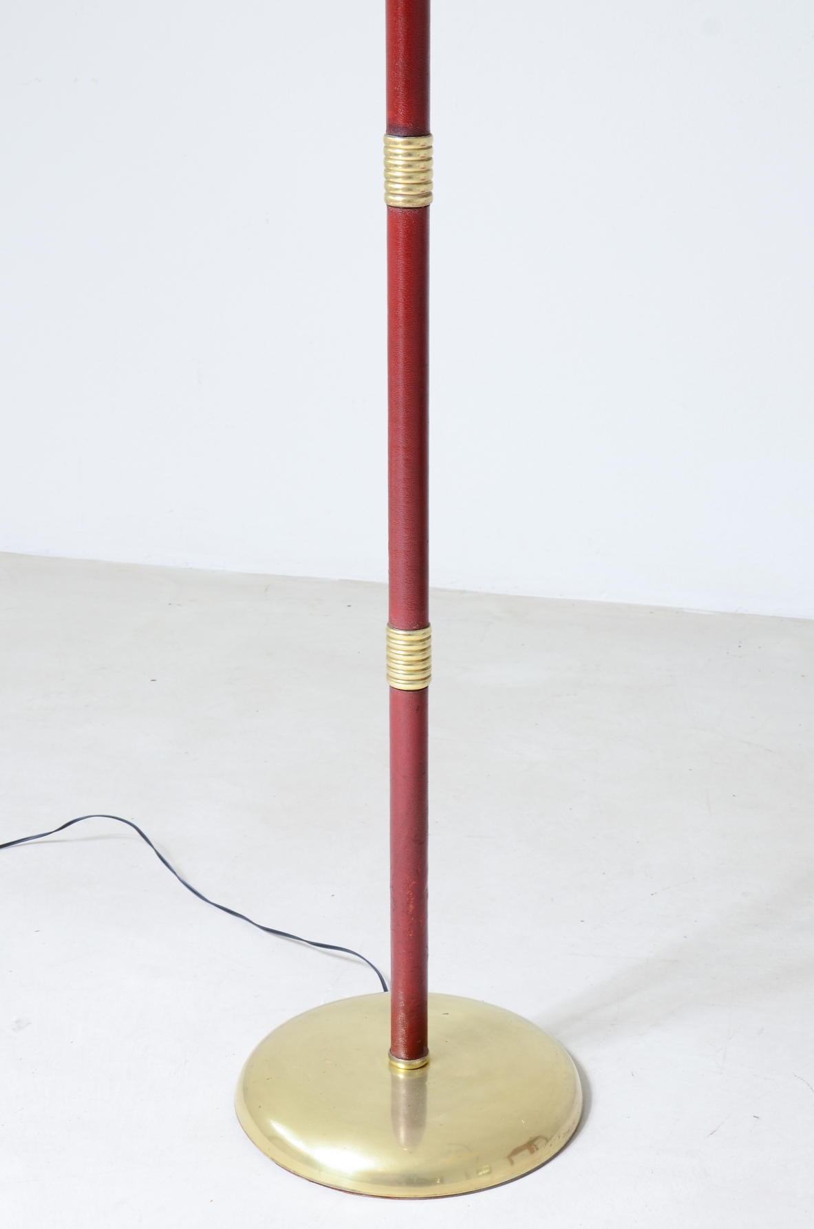 Floor lamp with adjustable brass stem and leather details, elegant parchment lampshade.  Italian manufacture 1930's.