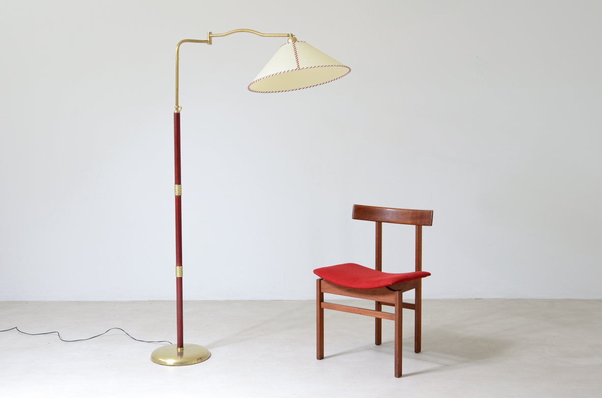 Floor lamp with adjustable brass stem and leather details, elegant parchment lampshade.  Italian manufacture 1930's.