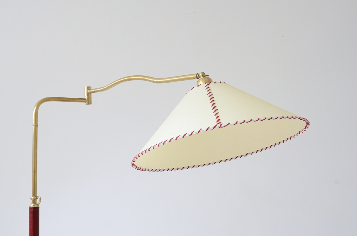 Floor lamp with adjustable brass stem and leather details, elegant parchment lampshade.  Italian manufacture 1930's.