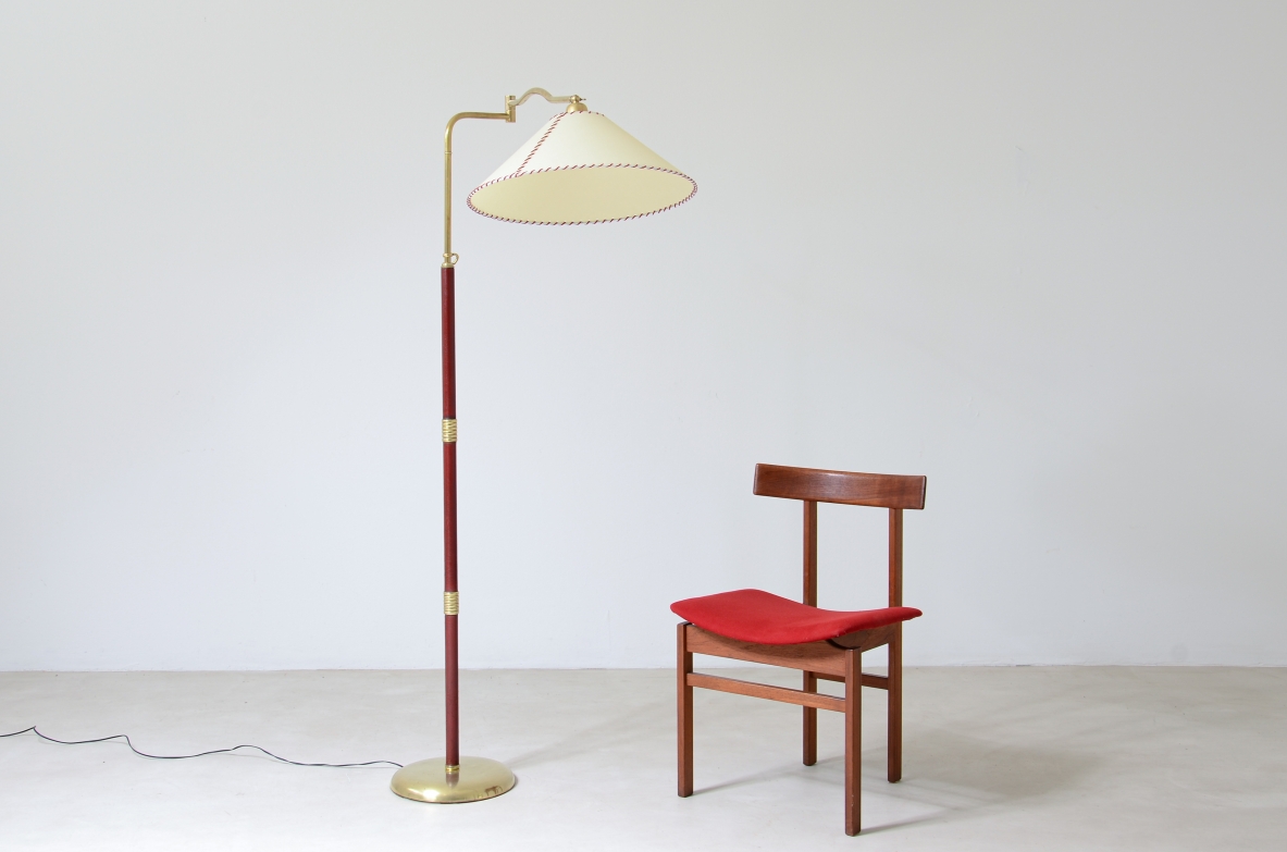 Floor lamp with adjustable brass stem and leather details, elegant parchment lampshade.  Italian manufacture 1930's.