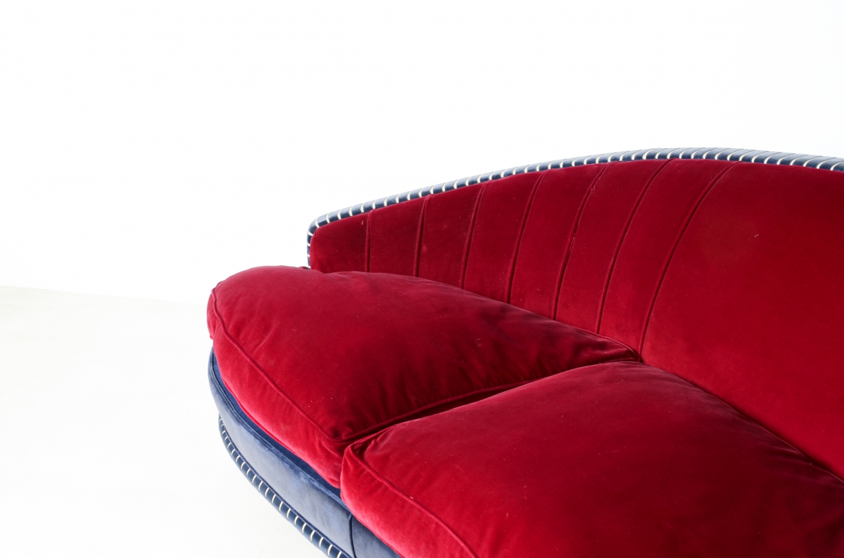 Living room composed of an elegant curved sofa and two armchairs ca. 1940.