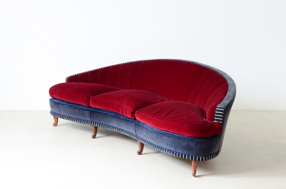 Living room composed of an elegant curved sofa and two armchairs ca. 1940.
