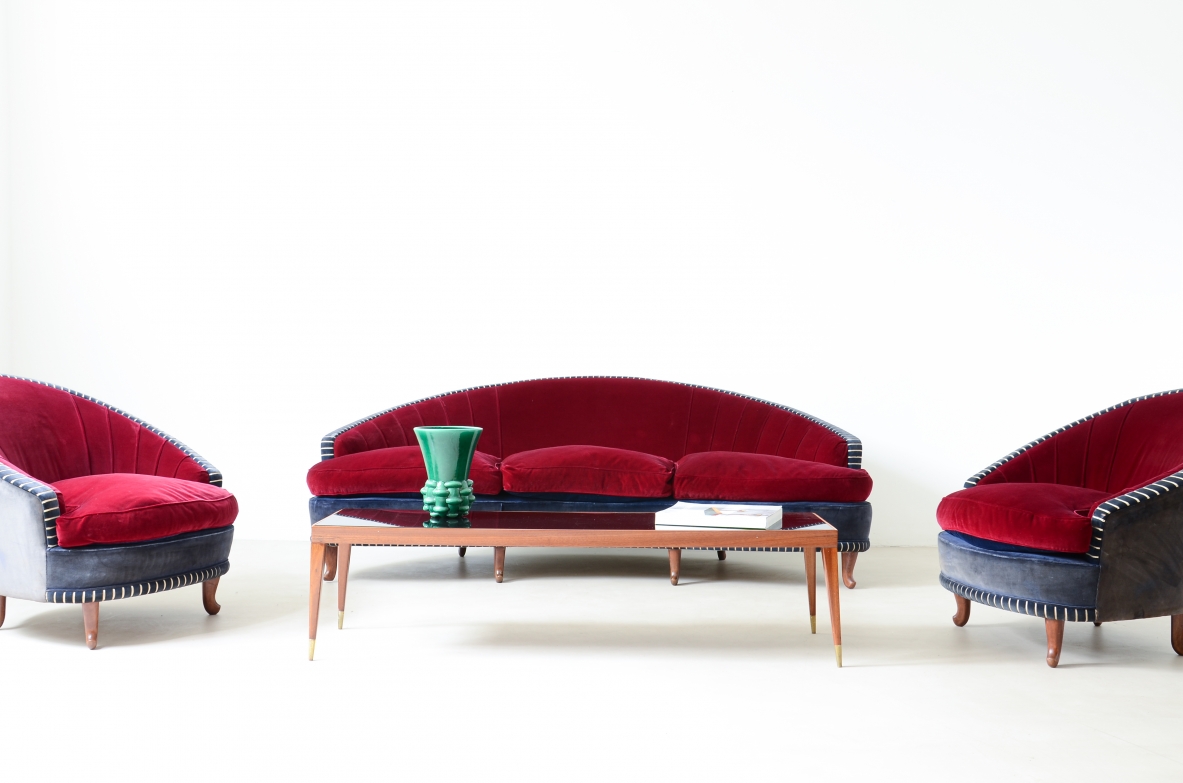 Living room composed of an elegant curved sofa and two armchairs ca. 1940.