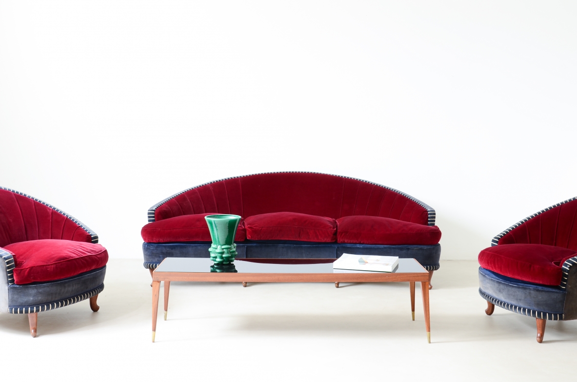Living room composed of an elegant curved sofa and two armchairs ca. 1940.