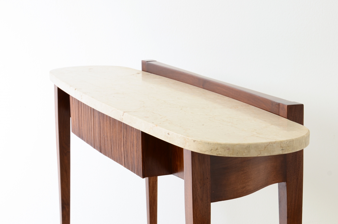 Elegant console moved on the front and sides, drawers and oval travertine top,