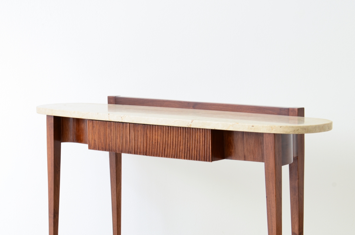 Elegant console moved on the front and sides, drawers and oval travertine top,