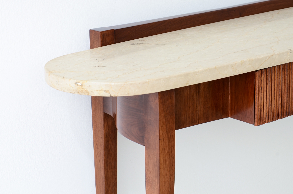Elegant console moved on the front and sides, drawers and oval travertine top,