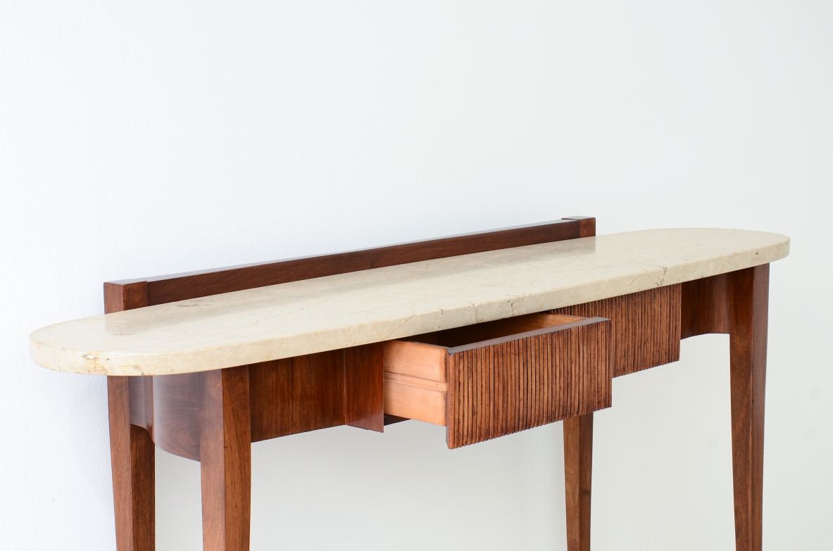 Elegant console moved on the front and sides, drawers and oval travertine top,